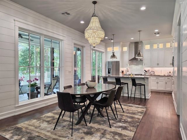 dining room featuring plenty of natural light, dark wood-type flooring, and ornamental molding