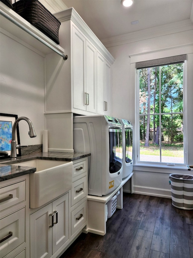 laundry room with washer and dryer, dark hardwood / wood-style floors, a wealth of natural light, and cabinets