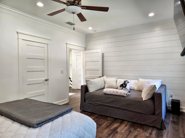 bedroom with ceiling fan, crown molding, and dark wood-type flooring