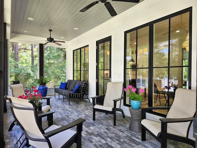 view of terrace with an outdoor living space and ceiling fan