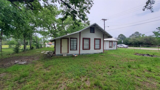 rear view of house featuring a yard