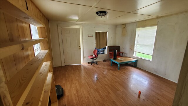 unfurnished room featuring wooden walls and hardwood / wood-style floors