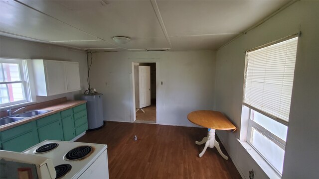 kitchen with water heater, wood-type flooring, range, white cabinetry, and sink