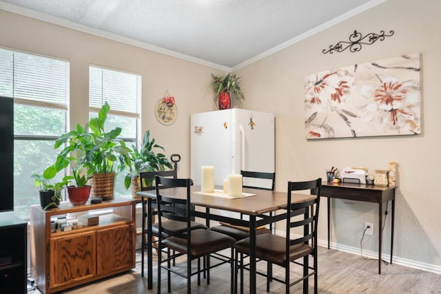 dining room with crown molding, hardwood / wood-style flooring, and a textured ceiling