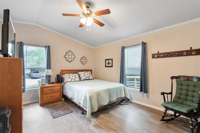 bedroom featuring a textured ceiling, ceiling fan, crown molding, and hardwood / wood-style flooring