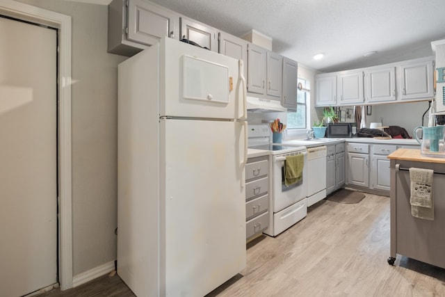 kitchen featuring white appliances and light wood-type flooring