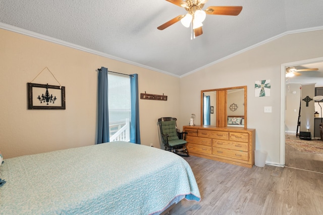 bedroom with ornamental molding, wood-type flooring, ceiling fan, and a textured ceiling