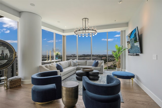 living room featuring a notable chandelier and wood-type flooring