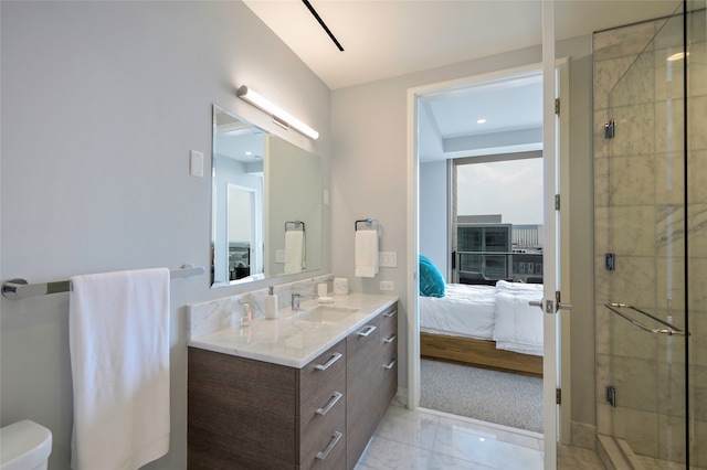 bathroom with tile patterned floors, a shower with door, vanity, and toilet