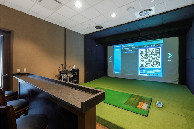 rec room featuring a drop ceiling and golf simulator