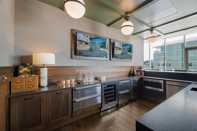 kitchen featuring wall oven, wine cooler, stainless steel dishwasher, and dark hardwood / wood-style floors