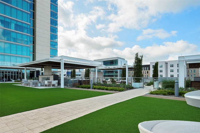 view of home's community with a patio and a yard