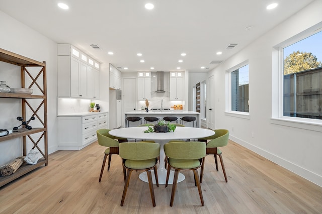 dining space with light hardwood / wood-style flooring