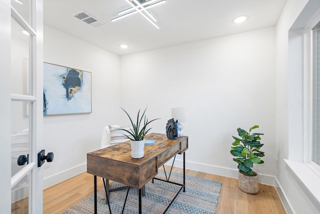 home office with hardwood / wood-style flooring