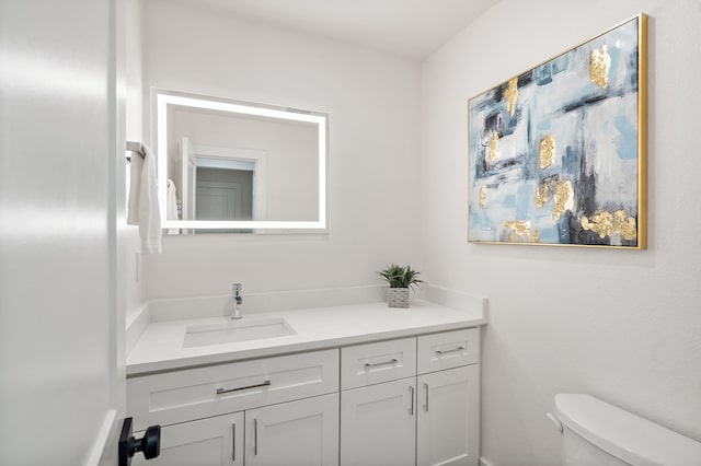 bathroom featuring vanity and toilet