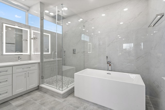 bathroom featuring tile flooring, tile walls, and plus walk in shower