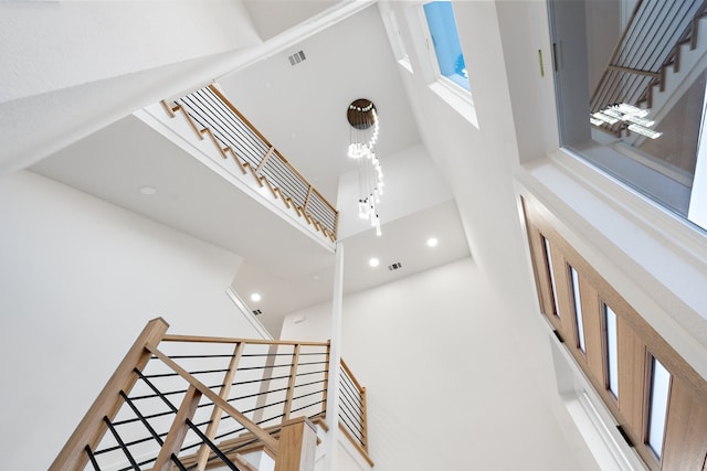 staircase featuring a high ceiling