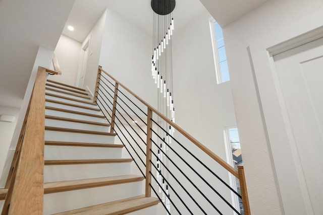 staircase with a towering ceiling