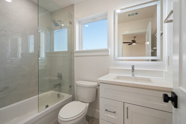 full bathroom with bath / shower combo with glass door, vanity, toilet, and ceiling fan