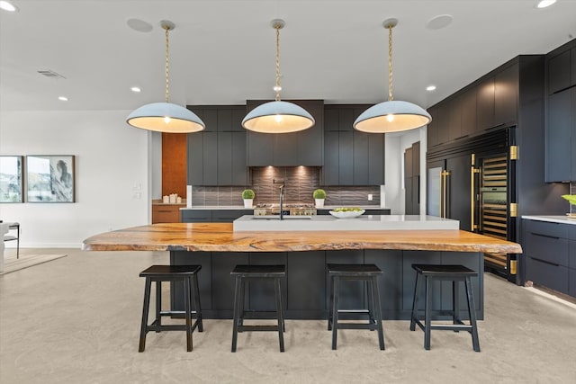 kitchen with backsplash, a large island, and pendant lighting