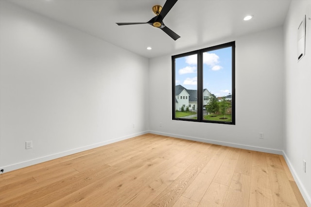 spare room featuring ceiling fan and light hardwood / wood-style flooring