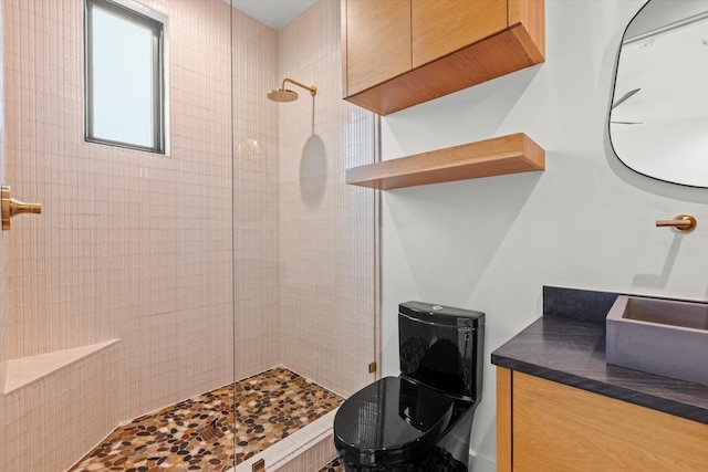 bathroom featuring tiled shower and sink