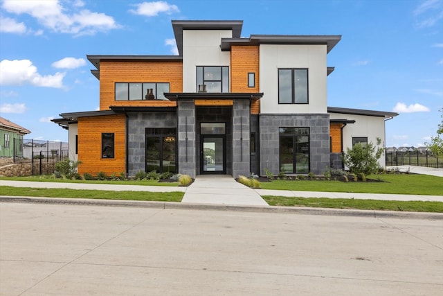 modern home with a front lawn