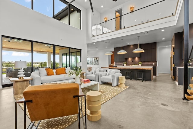 living room featuring a towering ceiling