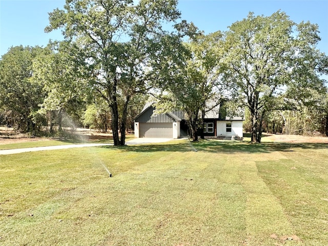 view of front of property with a front lawn and a garage