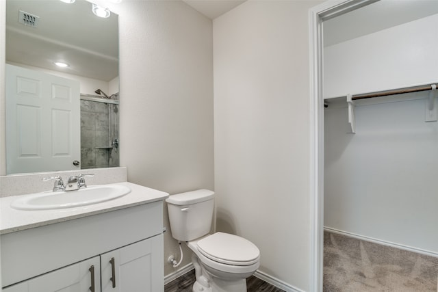 bathroom with vanity with extensive cabinet space and toilet