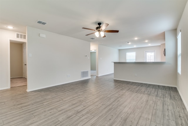 spare room featuring ceiling fan and light wood-type flooring