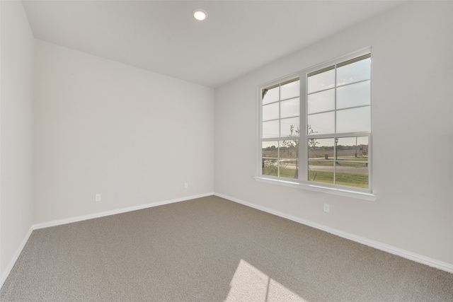 empty room with a healthy amount of sunlight and carpet