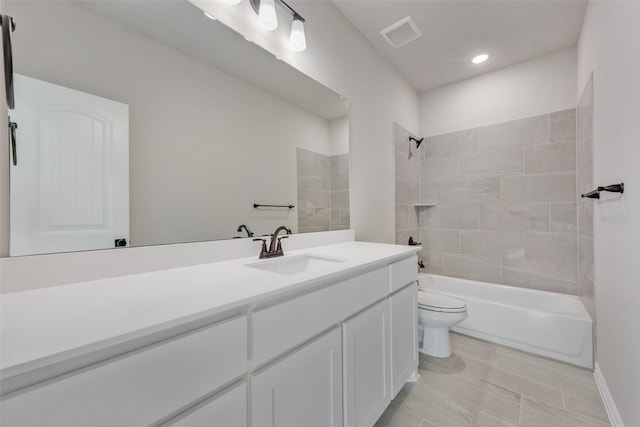 full bathroom featuring vanity, tiled shower / bath combo, and toilet