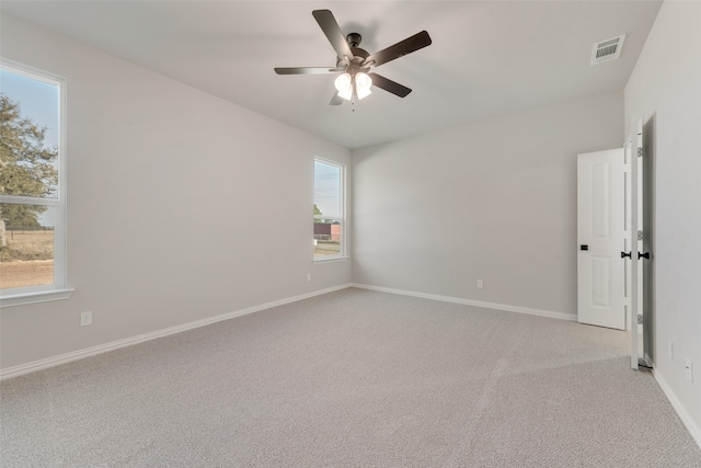 carpeted empty room featuring ceiling fan