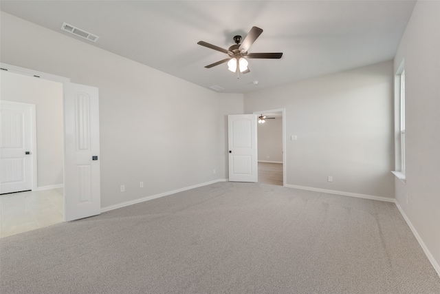 unfurnished room with ceiling fan and light carpet