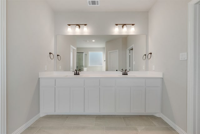 bathroom featuring vanity, an enclosed shower, and tile patterned floors