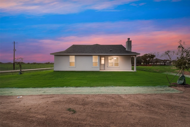 view of front of home with a lawn