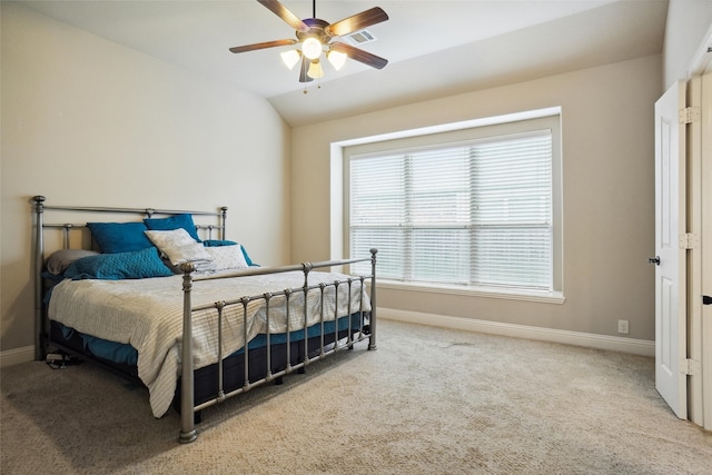 bedroom featuring vaulted ceiling, carpet floors, and multiple windows