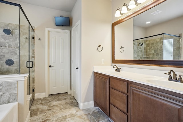 bathroom with vanity with extensive cabinet space, double sink, shower with separate bathtub, and tile flooring