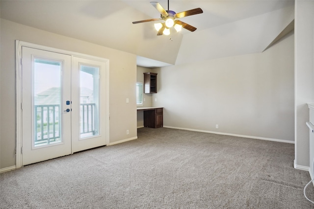 unfurnished living room with vaulted ceiling, french doors, carpet, and plenty of natural light