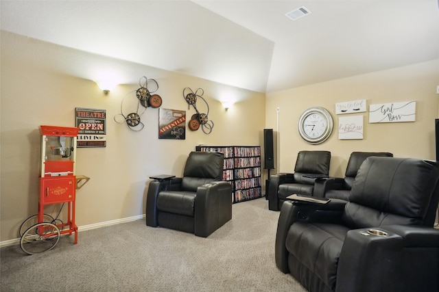 carpeted home theater room featuring vaulted ceiling