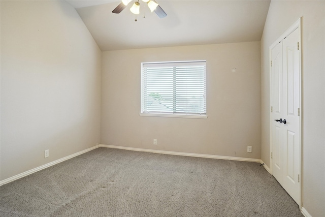 unfurnished room featuring ceiling fan, vaulted ceiling, and carpet flooring