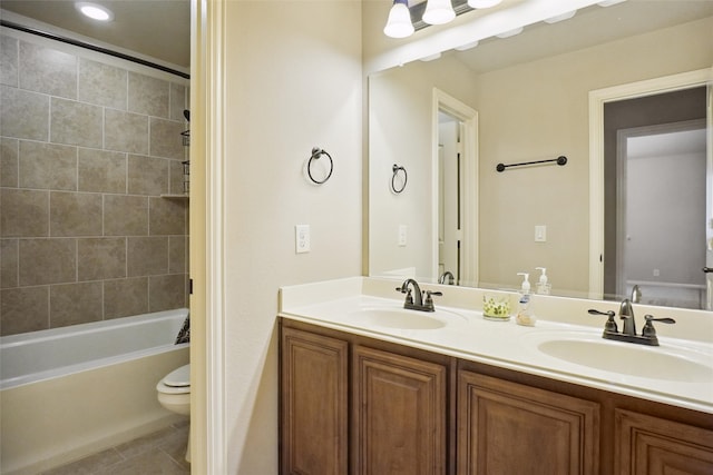 full bathroom with tiled shower / bath, oversized vanity, tile flooring, dual sinks, and toilet