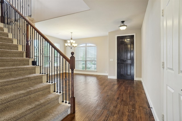 foyer featuring dark hardwood / wood-style flooring and a notable chandelier