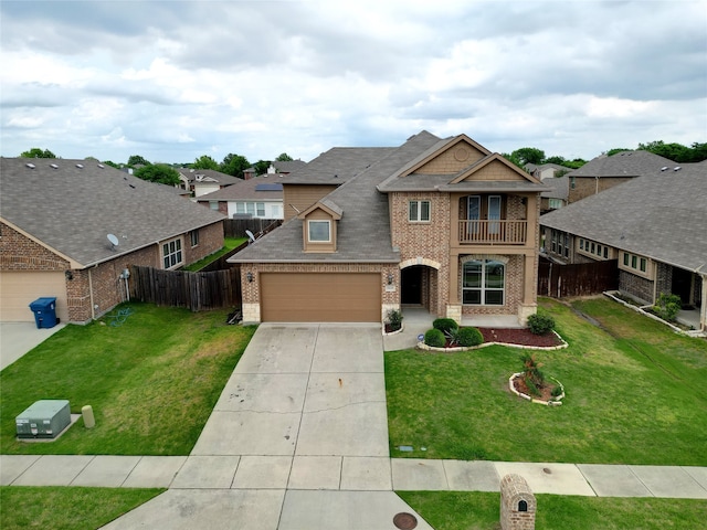 view of front of home with a balcony and a front yard