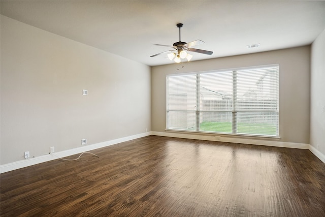 empty room with ceiling fan and dark hardwood / wood-style floors