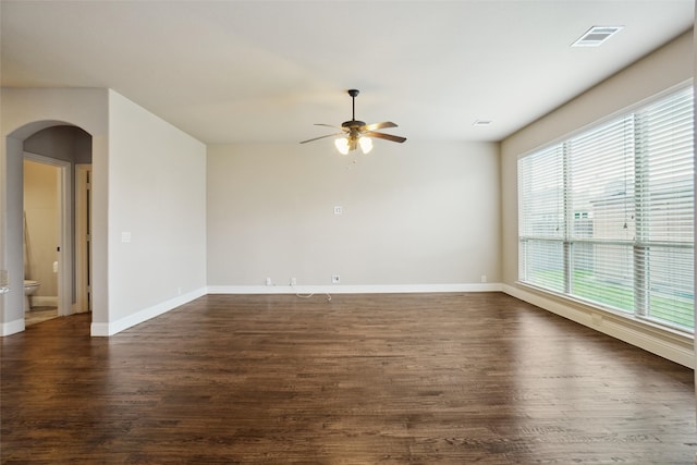 empty room featuring ceiling fan and dark hardwood / wood-style floors