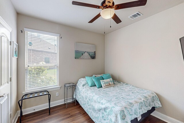 bedroom featuring dark hardwood / wood-style floors and ceiling fan