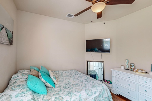 bedroom with dark hardwood / wood-style floors and ceiling fan