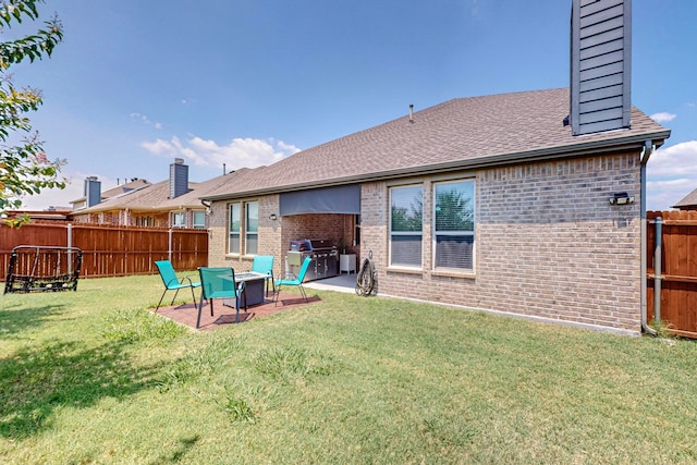 back of property featuring a yard and a patio area